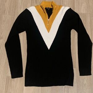 Elegant Black and White V-Neck Sweater with Gold Accent
